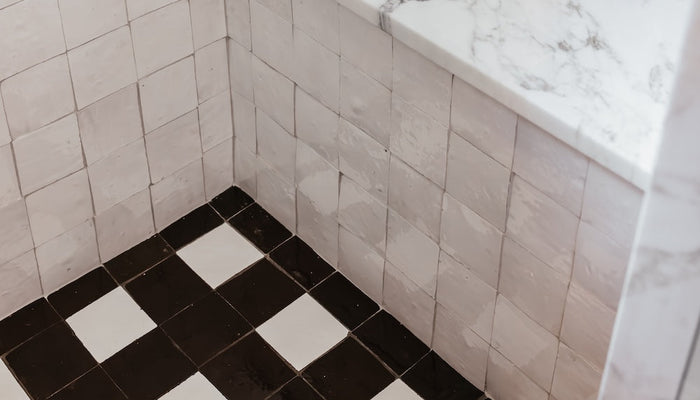 beyond basics: 11 shower floor tile ideas that tell a story