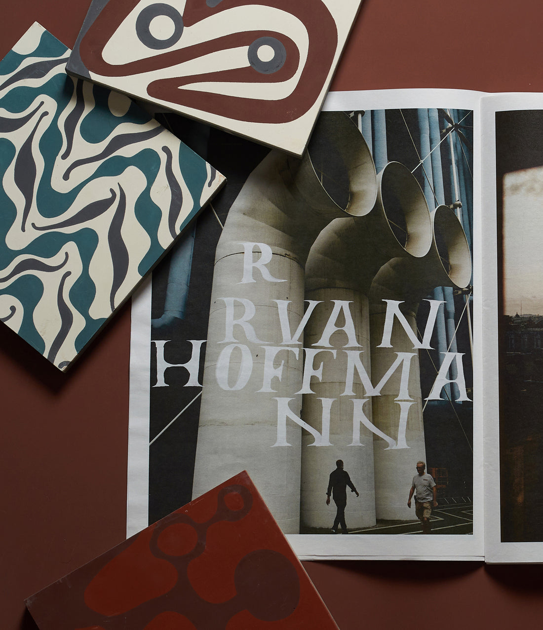 Open book with 'Ruan Hoffman' on a brown background with abstract patterns.