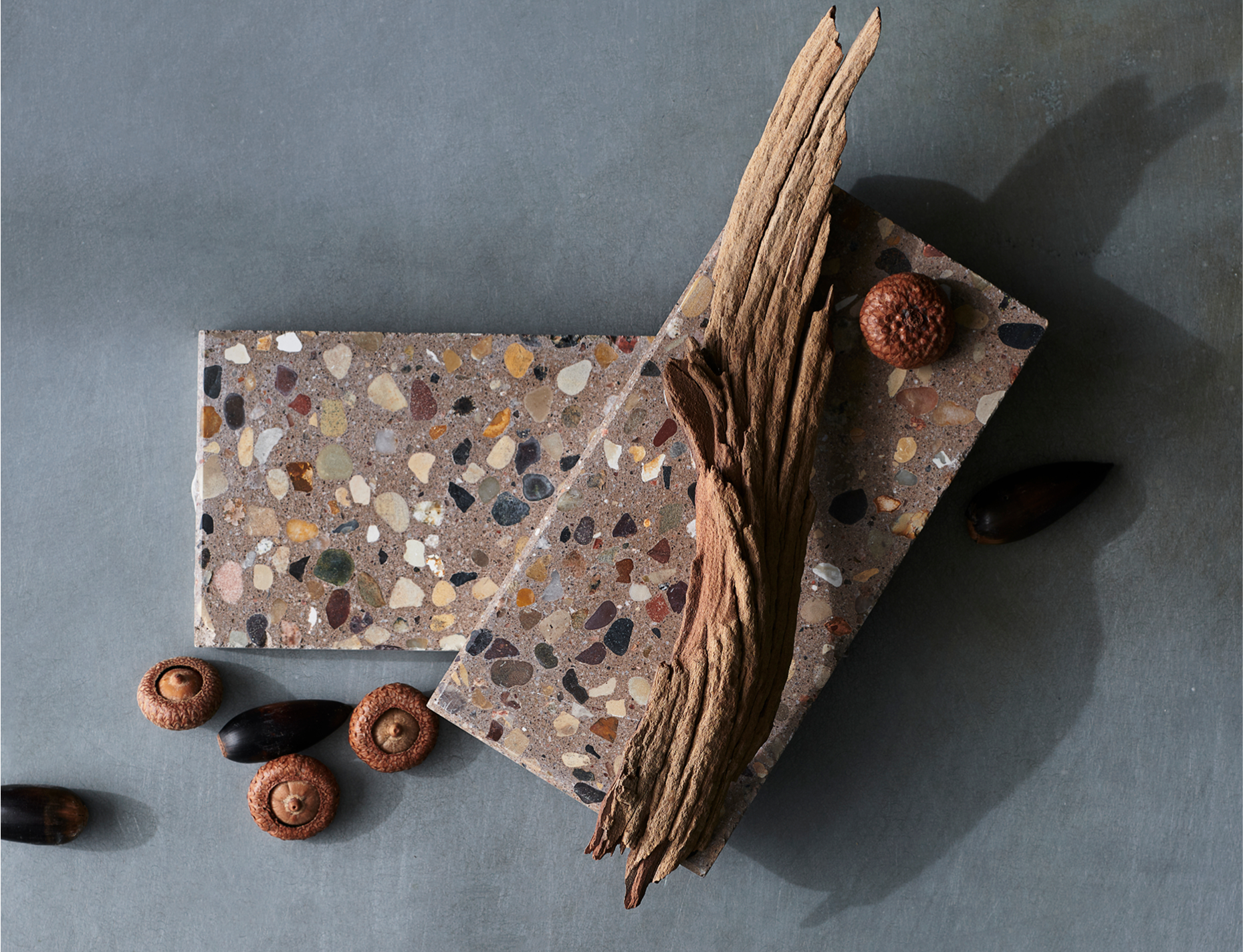 An elegant display of terrazzo tiles against a grey background