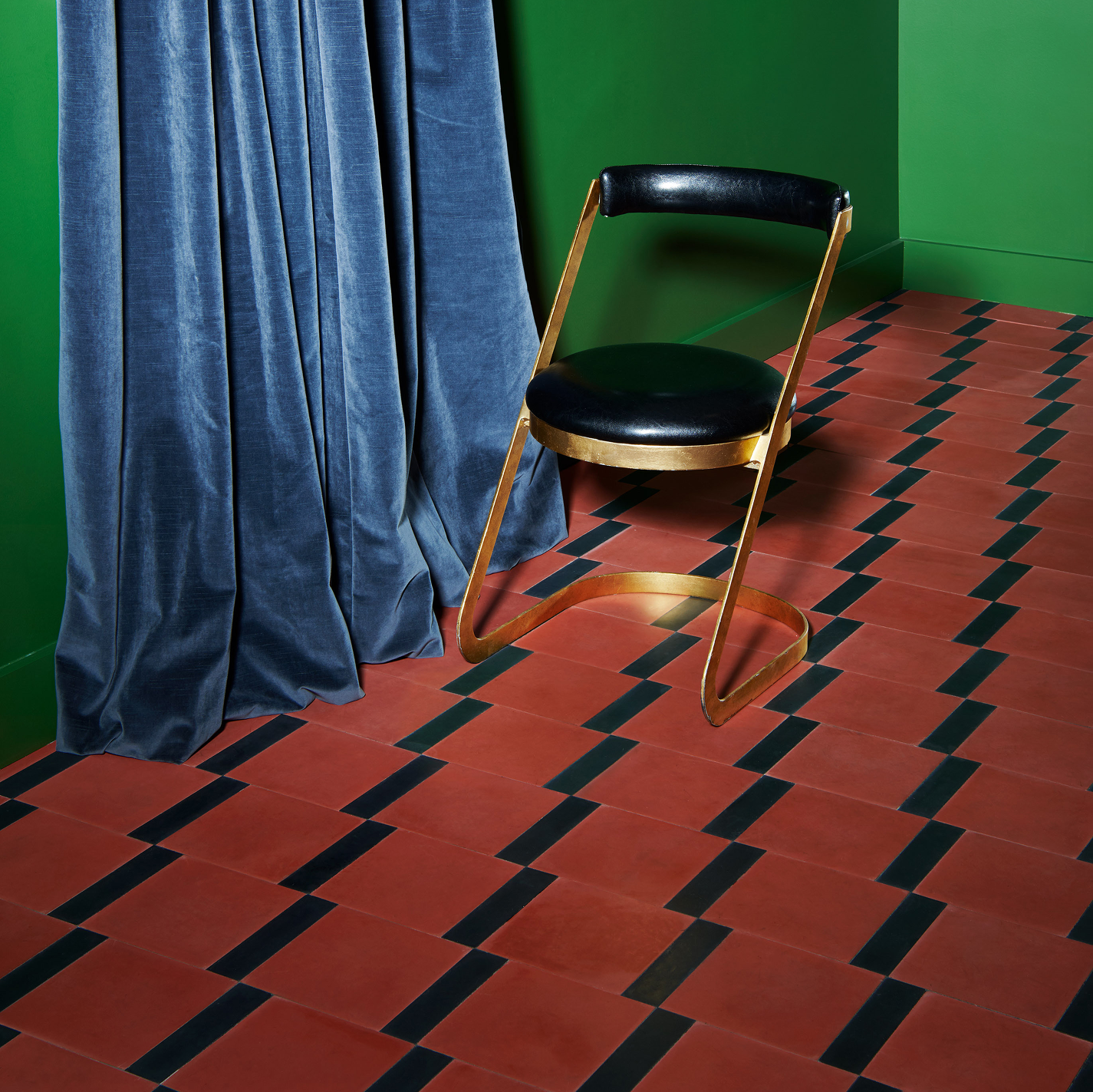 Black chair on a red and black cement floor