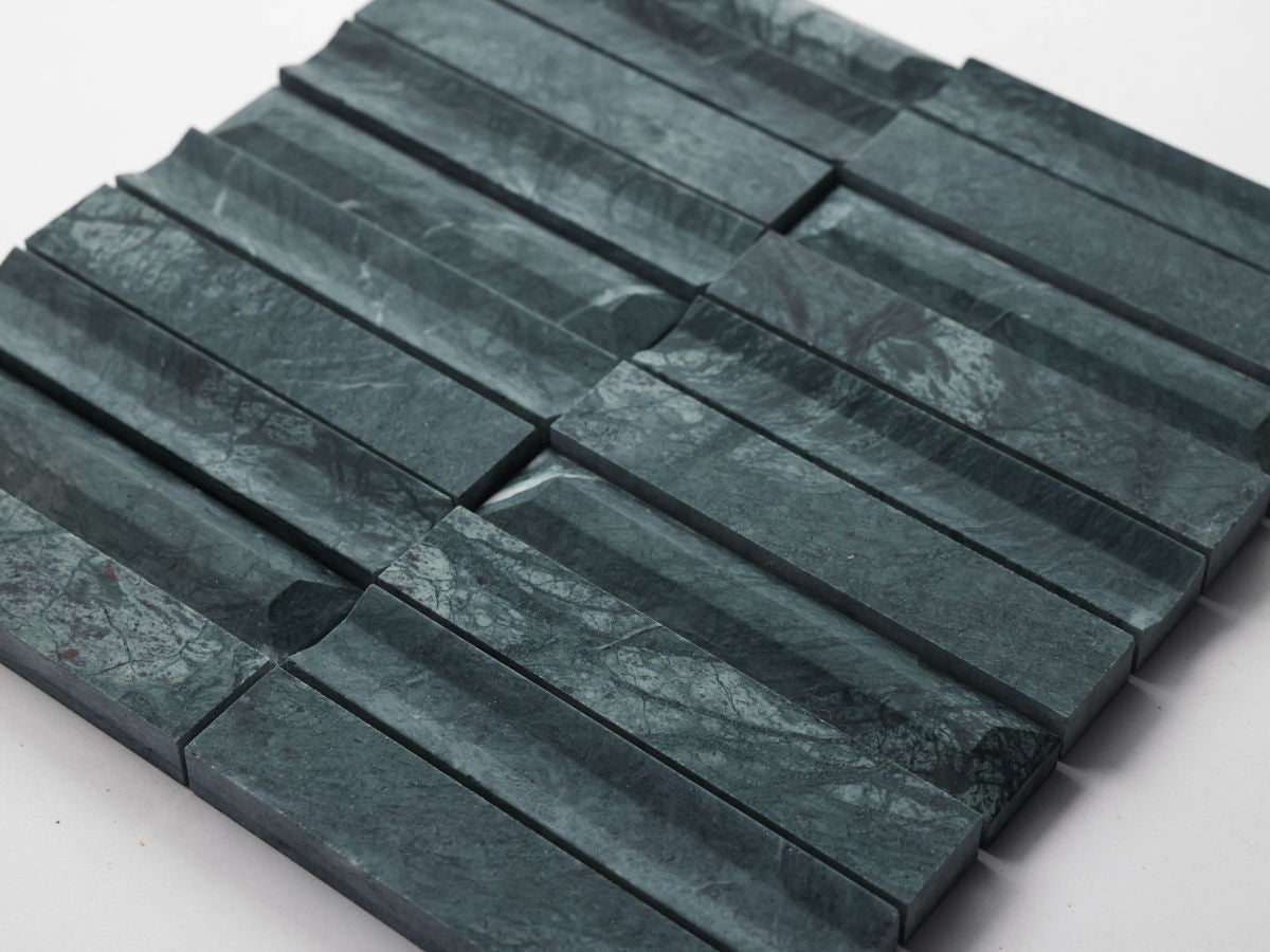 Rectangular dark green marble tiles with a textured, grooved surface are arranged in a grid pattern on a white background.
