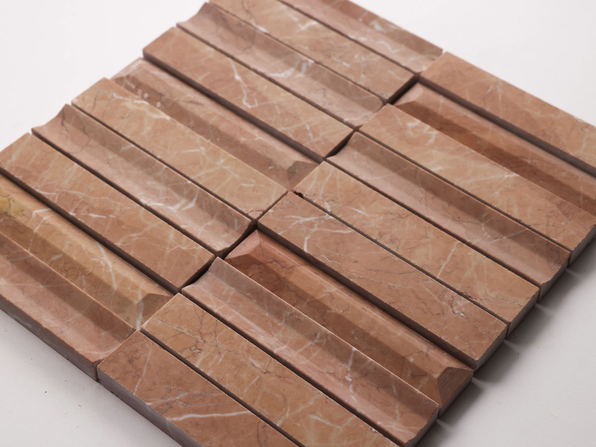 A tile panel composed of rectangular, reddish-brown marble pieces with white veining, featuring a 3D ridged surface pattern.