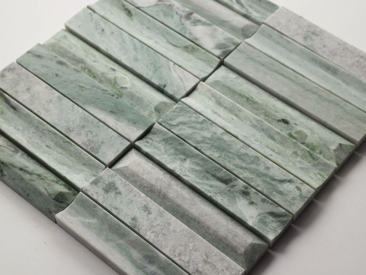 Rectangular green and gray marble tiles are arranged in a staggered pattern on a white background.