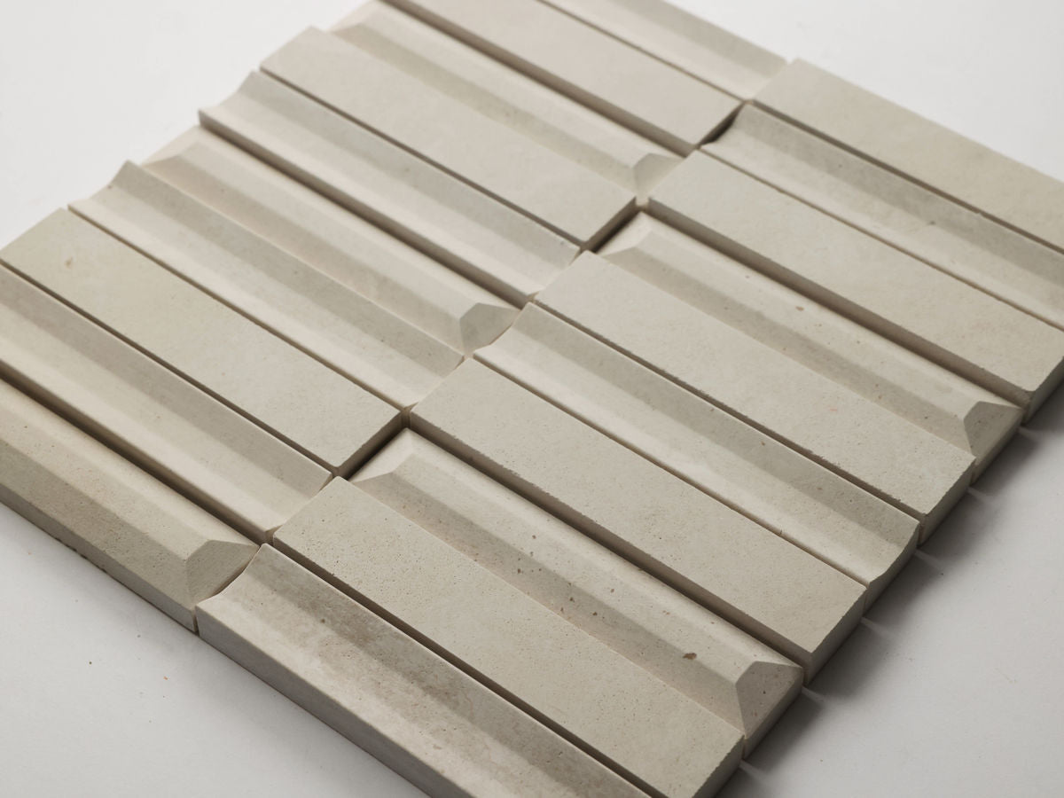 Beige textured tiles arranged in a repeating pattern.