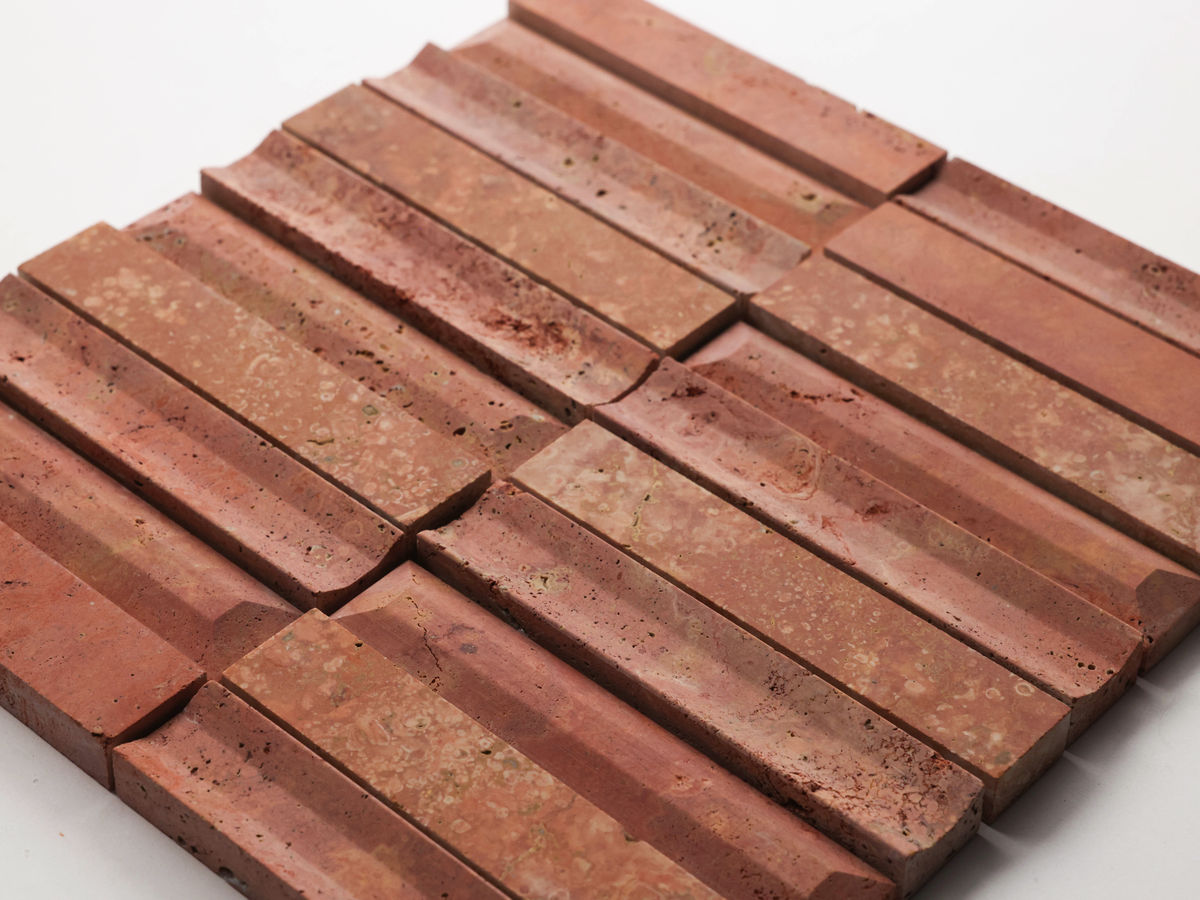 A close-up of textured, rectangular reddish-brown tiles arranged in a grid pattern on a white surface.