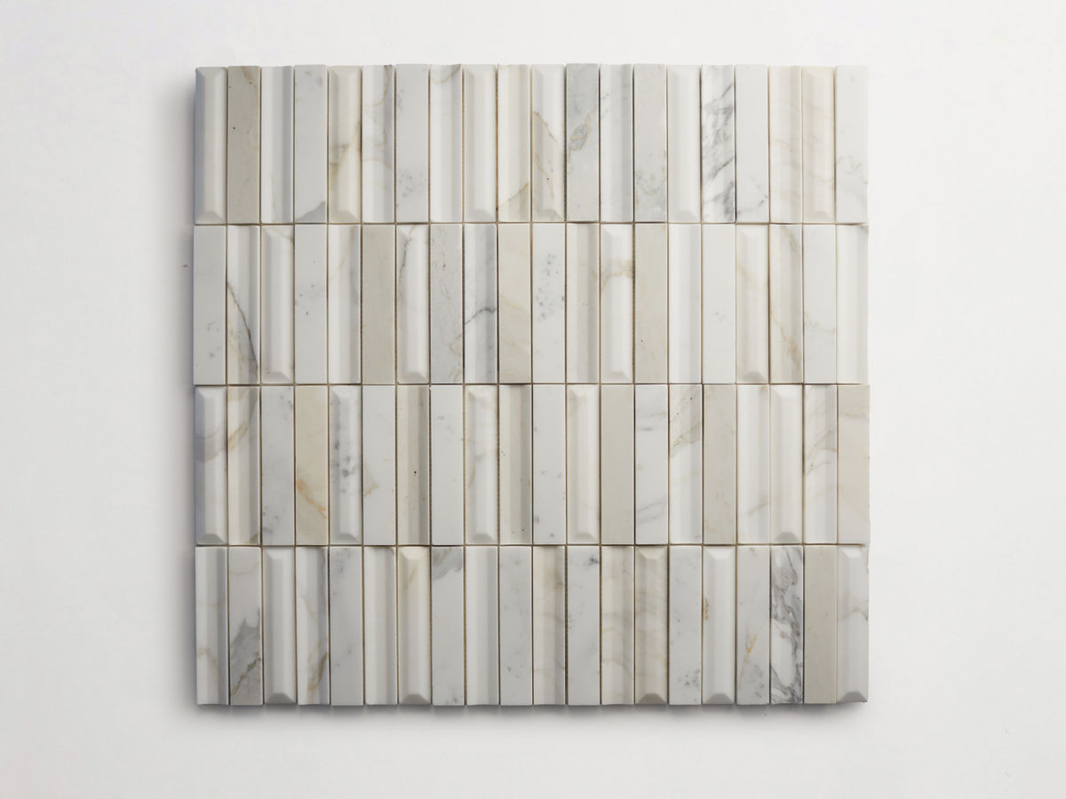 Square arrangement of rectangular, vertically oriented marble tiles with varying shades of white, gray, and beige, featuring subtle veining patterns.