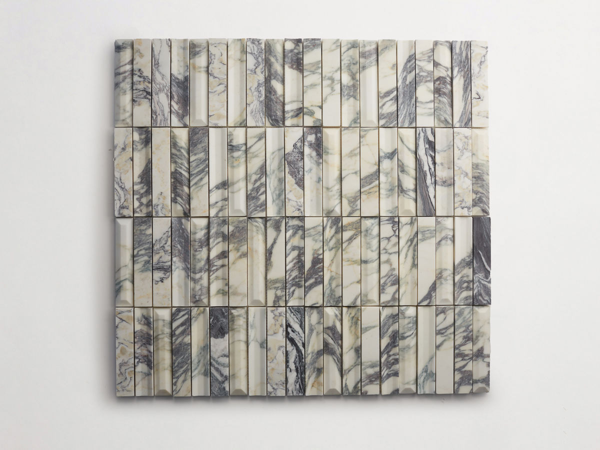 A square arrangement of rectangular marble tiles with varied gray veining, placed in a grid pattern on a white background.