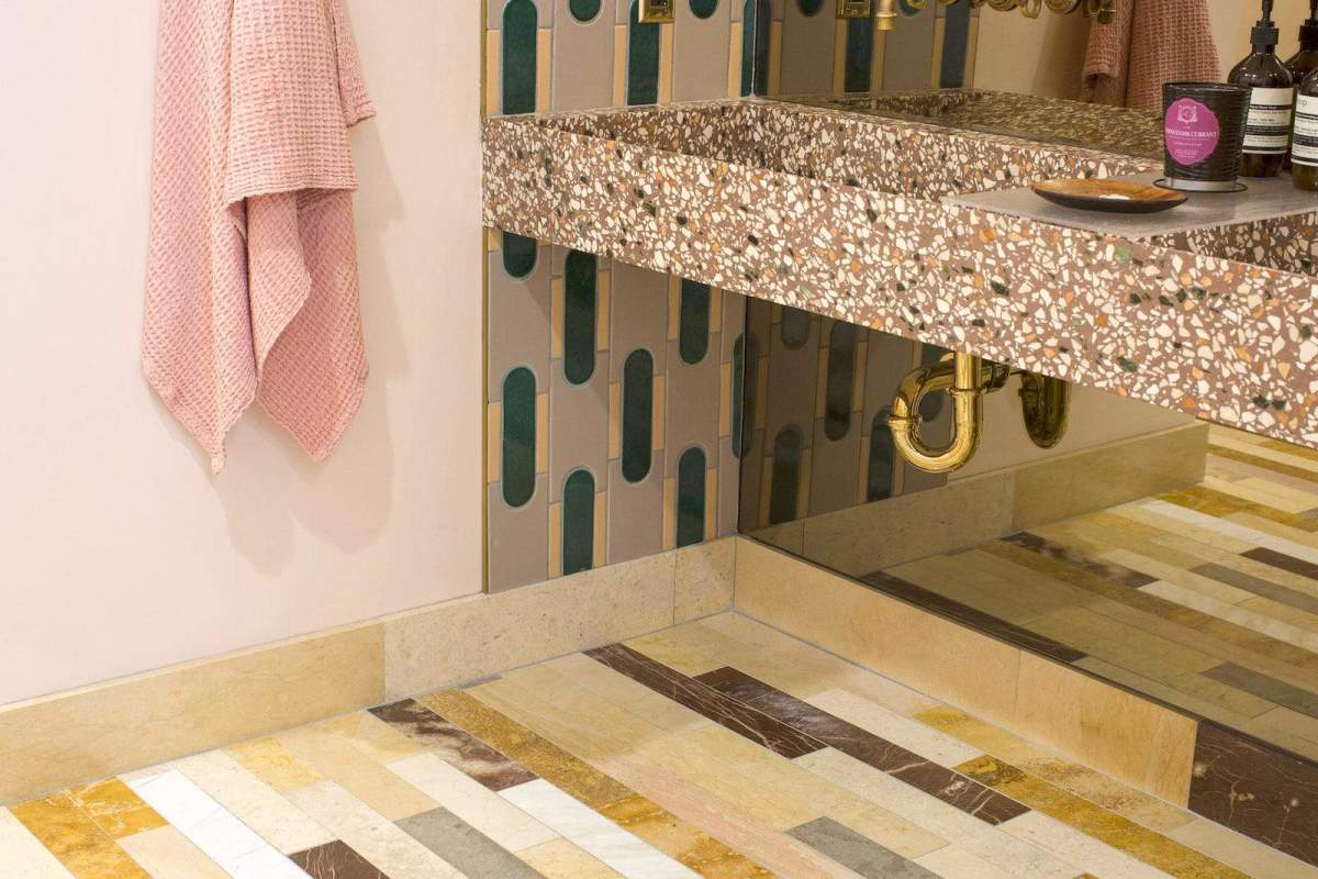 a bathroom with a sink, a mirror and a tile floor.