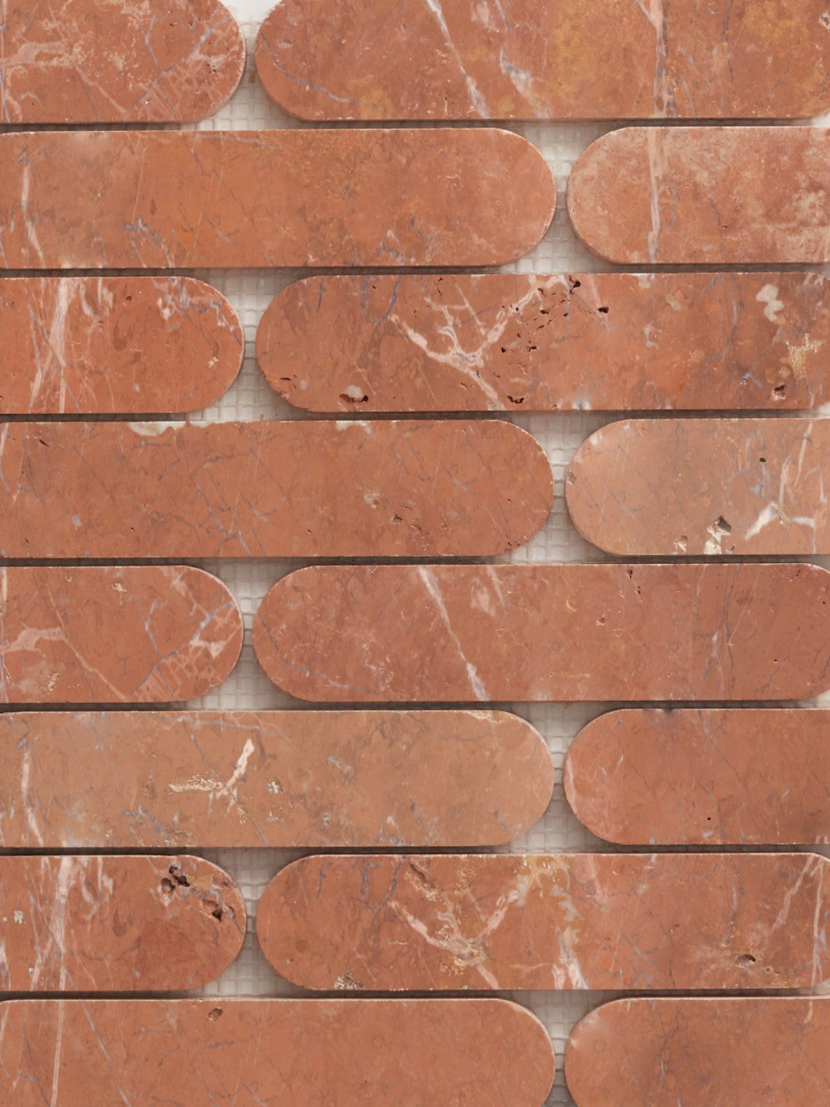 oval, red natural stone tiles arranged in a pattern.