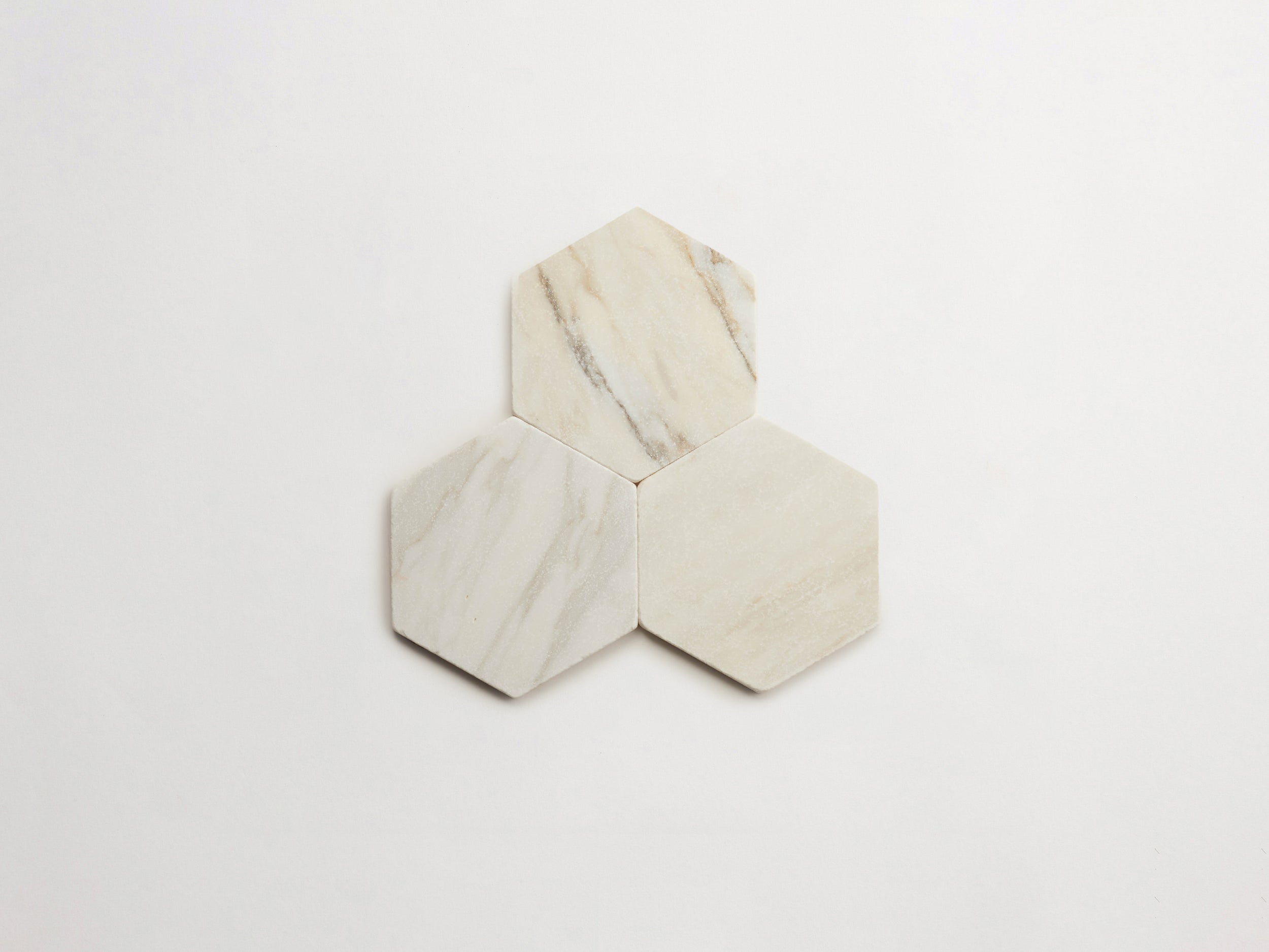 cle-tile-stone-tumbled-lapidary-calacatta-gold-hex-3up-3000x2250-300dpi .jpg