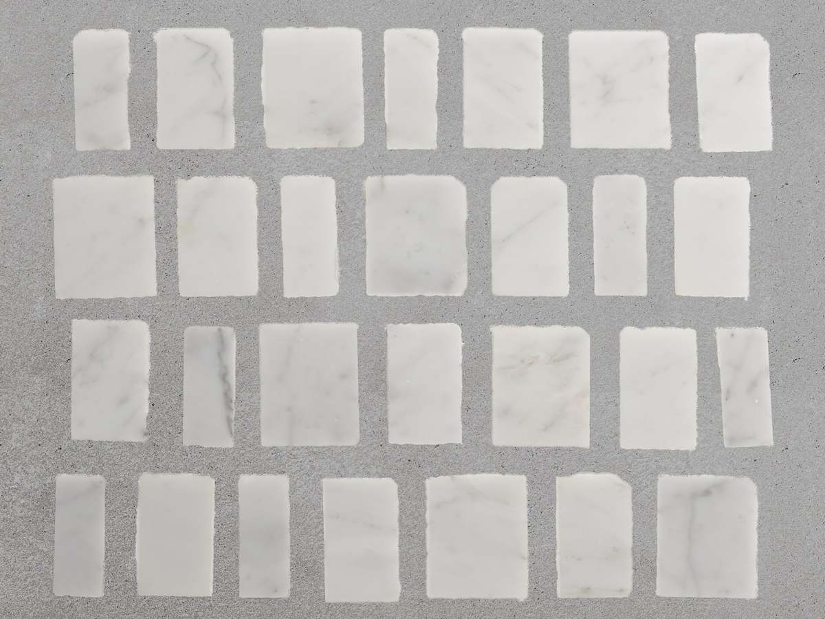 Carrara marble rough cut mosaic tile large joint.