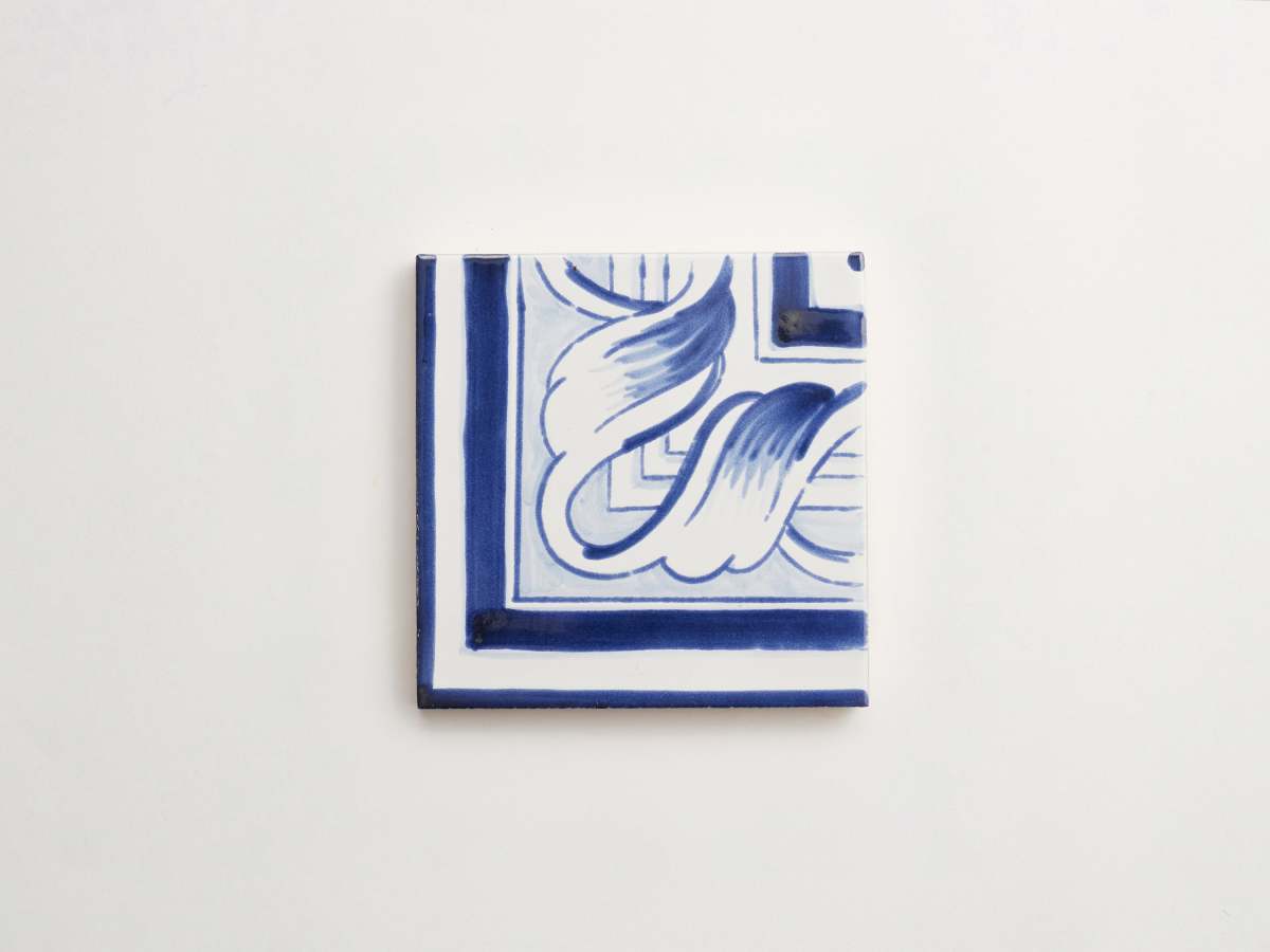 Painted blue ceramic delft tile square majolica backsplash.