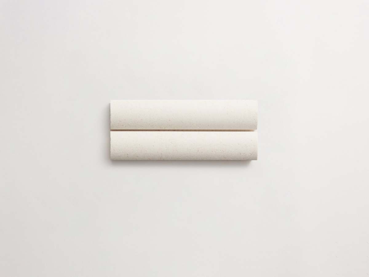 Rounded white 3d-tile limestone cabochon short.