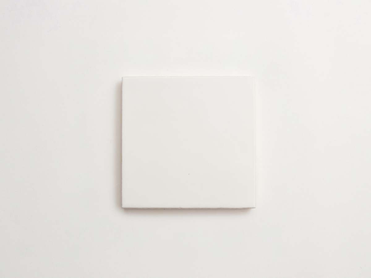 Painted white majolica square ceramic delft tile field.