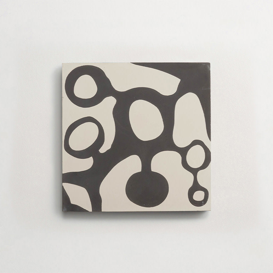 A square canvas with an abstract black and white pattern featuring organic, interconnected shapes and ovals on a plain background.
