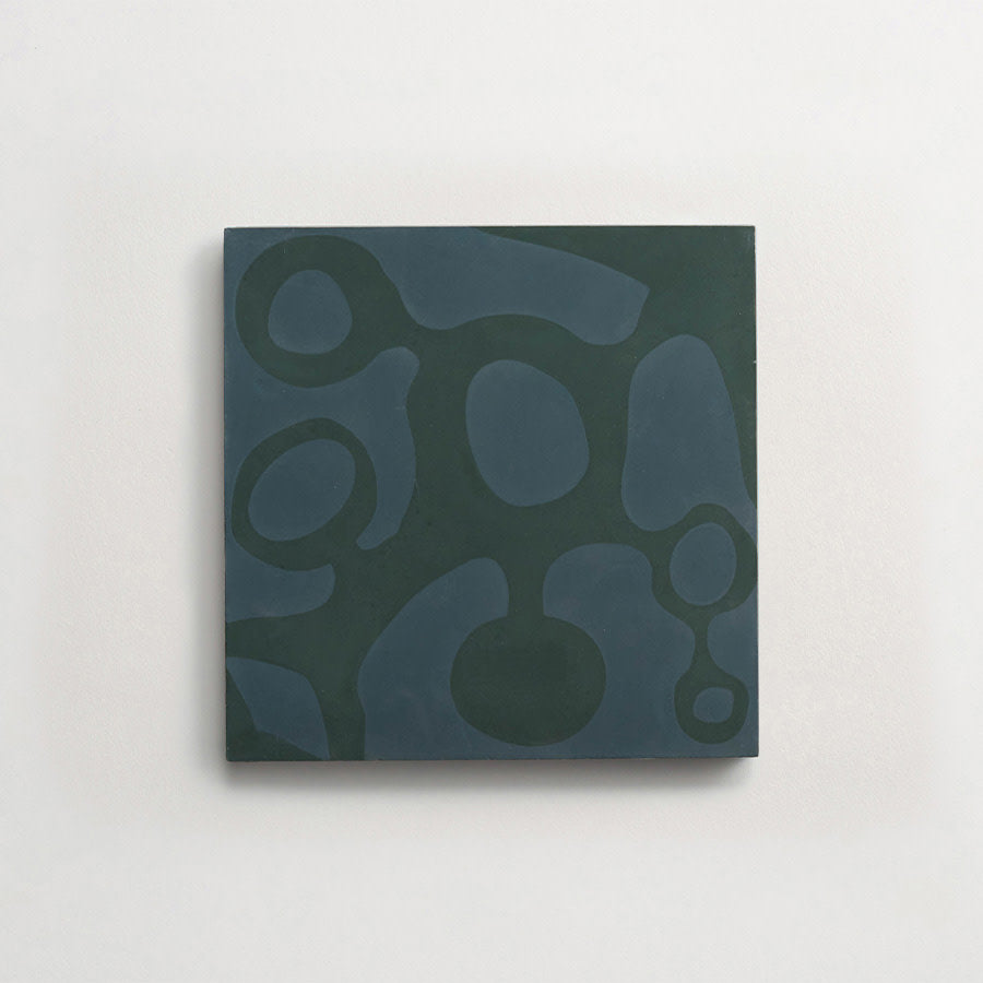 Square artwork with a dark green background and lighter abstract organic shapes arranged across the surface, mounted on a white wall.