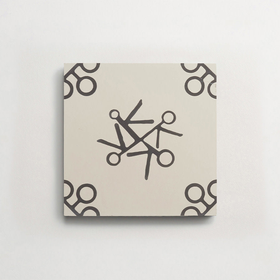 A square tile with a beige background features a black scissors pattern, with scissors arranged in a circular design at the center and corners.