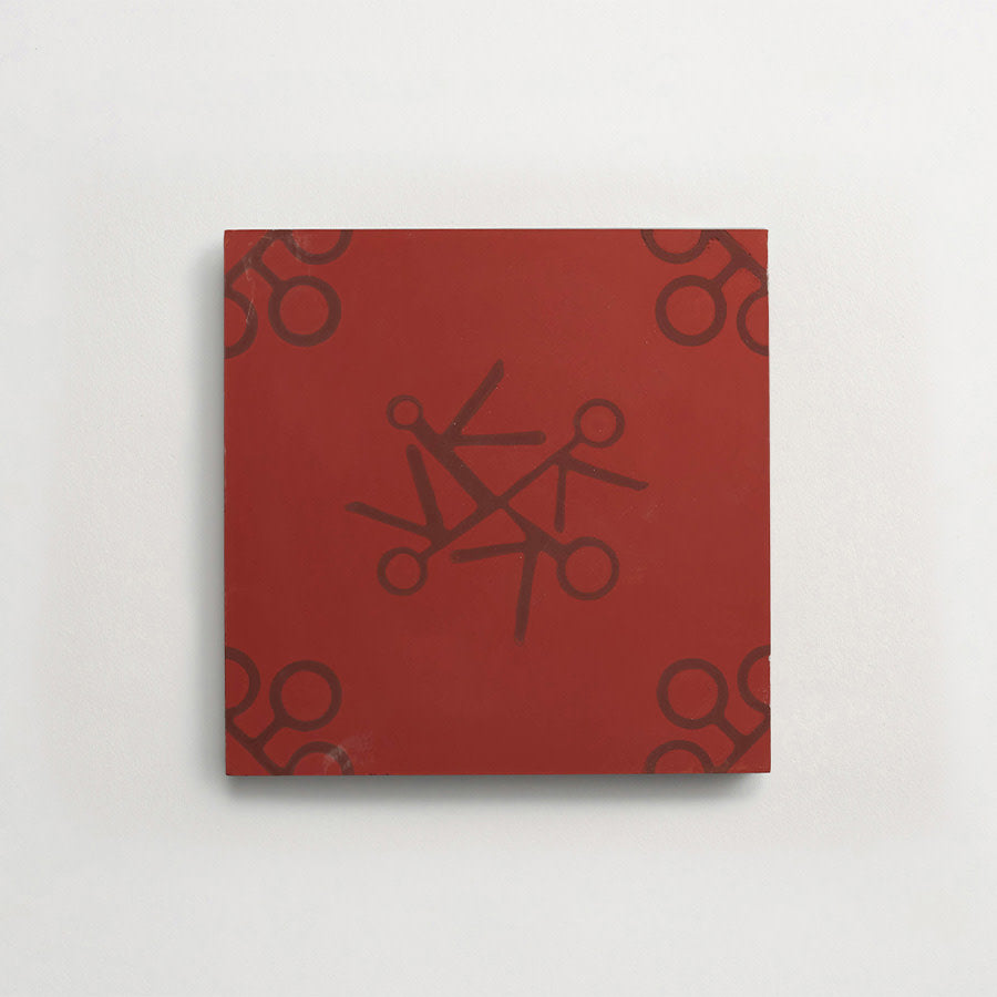 A square red canvas featuring black scissors motifs arranged in a circular pattern at the center and in each corner.