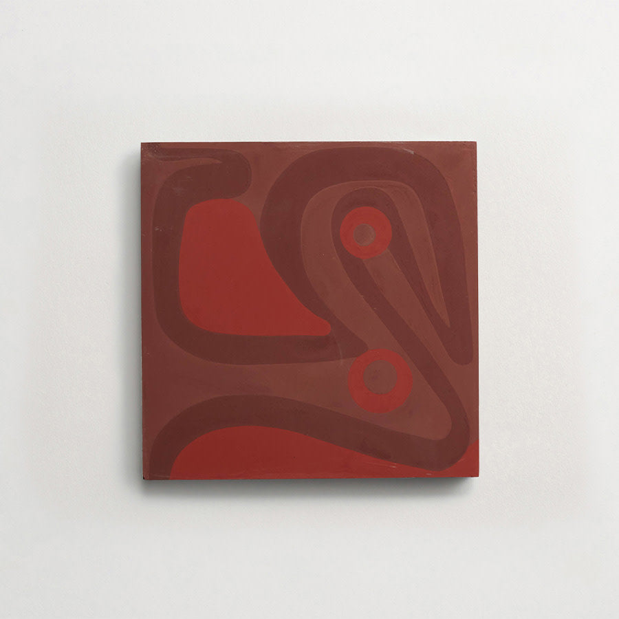 A square canvas with abstract, curving shapes and two circular forms in shades of red and brown, mounted on a white wall.
