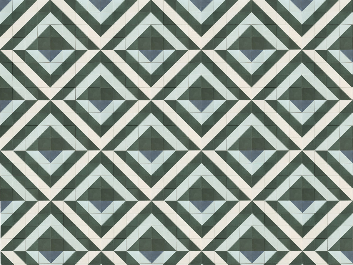 Geometric pattern of repeating diamond shapes in shades of green, blue, and white, forming an optical illusion across the surface.