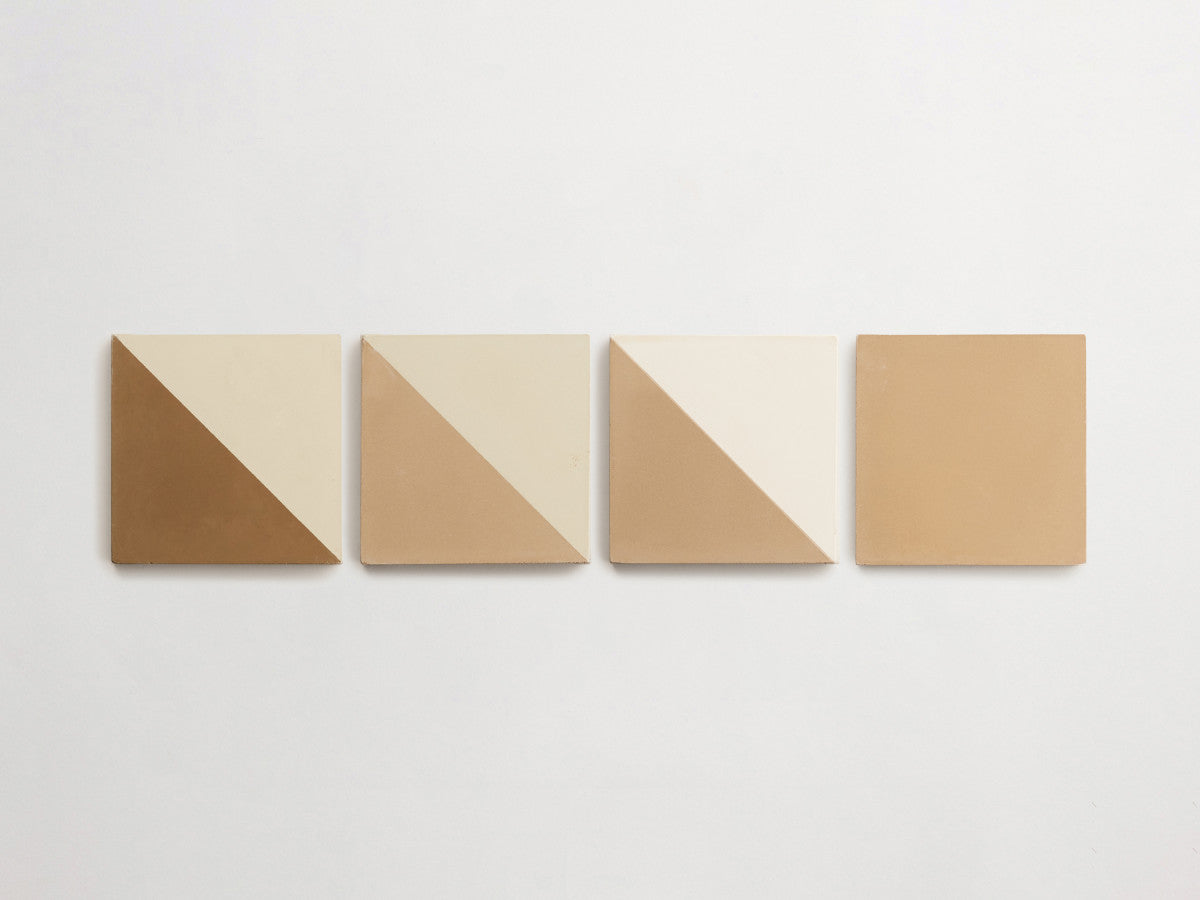 Four square tiles in a row, each with two-tone diagonal color patterns in shades of brown and beige, on a white background.