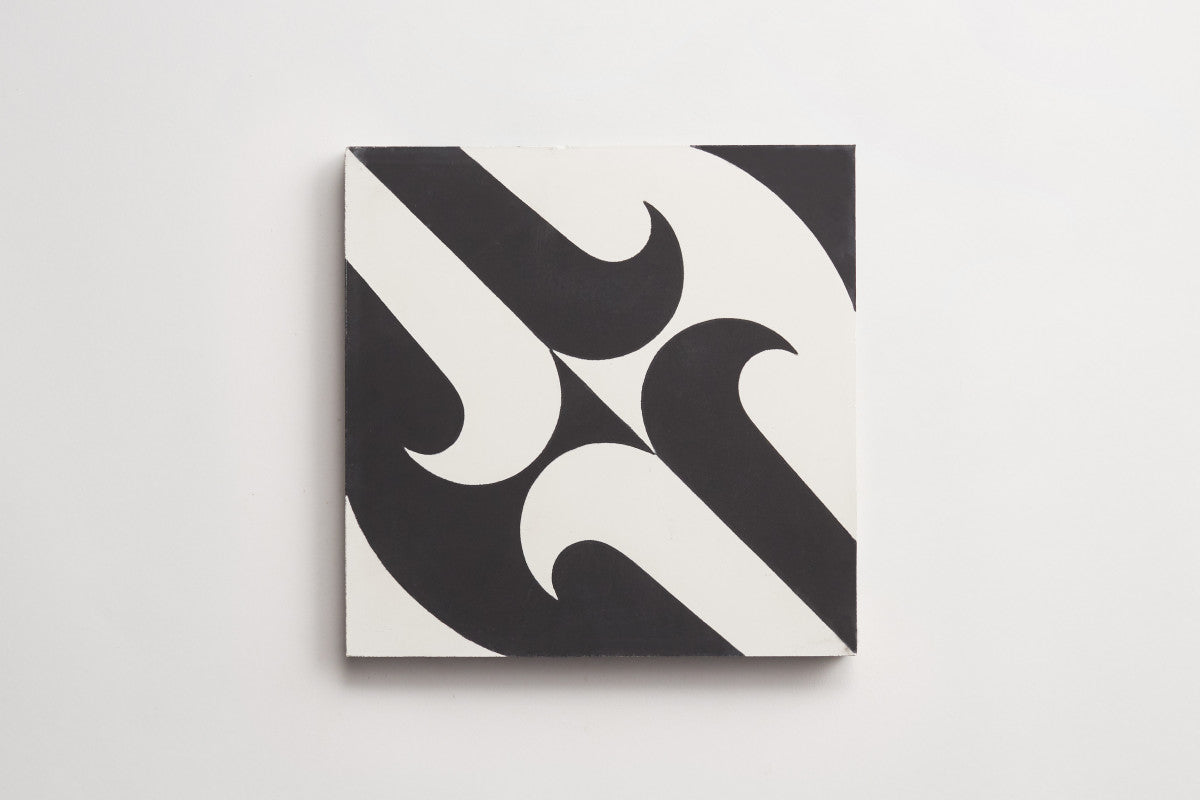 A square tile with a black and white geometric pattern featuring curved and pointed shapes creating a symmetrical design.