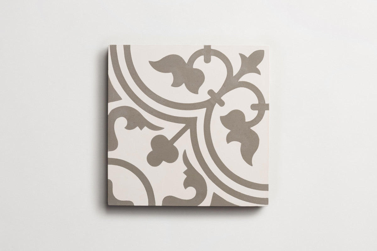 A square ceramic tile with a grey and white decorative floral and curved line pattern, shown on a plain white background.