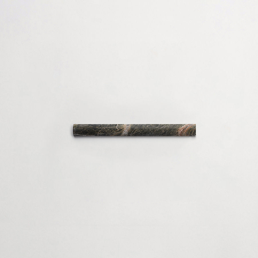 A single dark-colored cylindrical object, possibly a stone or metal rod, is placed horizontally on a plain white background.