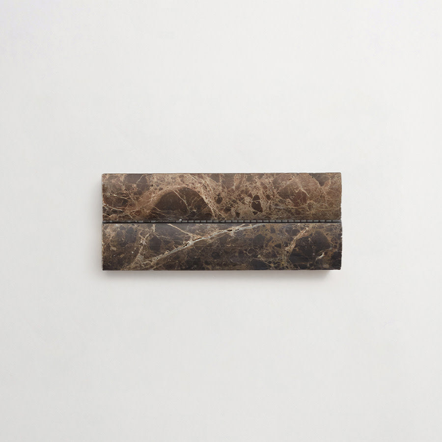 A rectangular object made of brown marble with natural veining, placed on a plain white background.