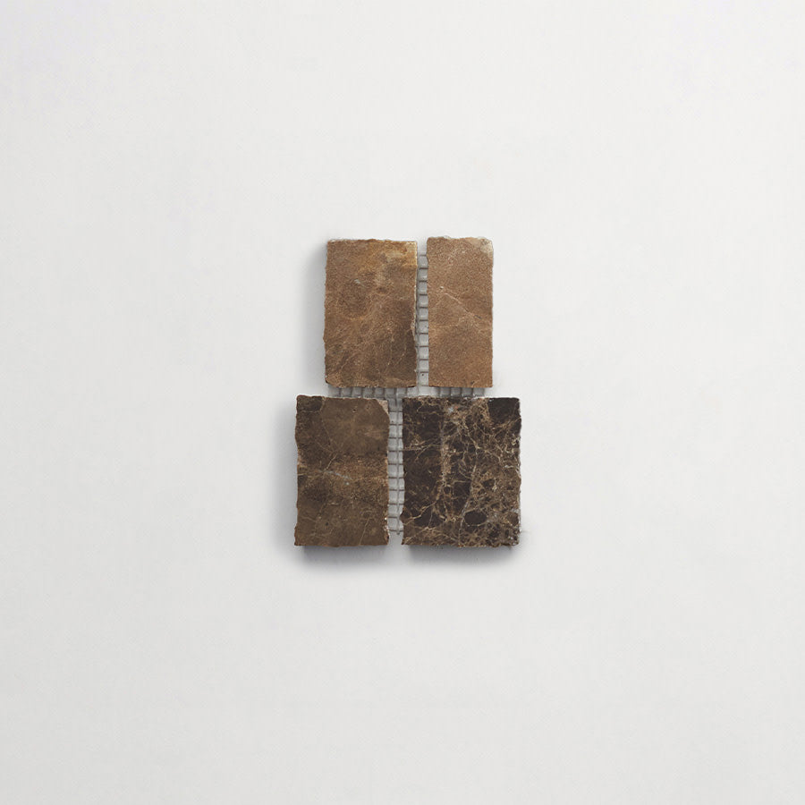 Four rectangular stone tiles, two lighter and two darker, are arranged in a grid pattern on a plain white background.