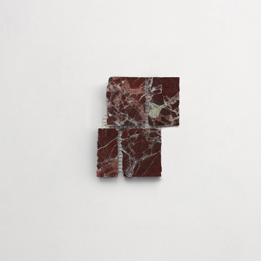 Four pieces of dark red marble with white and gray veins are arranged in a square formation on a plain white background.