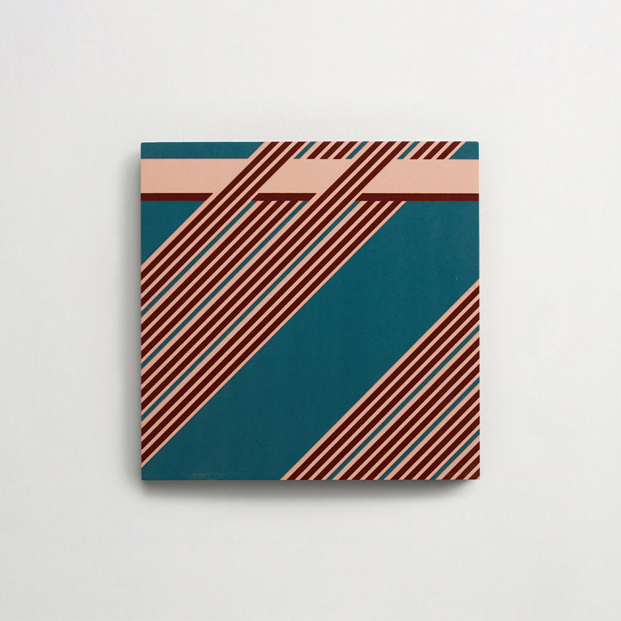 A square abstract painting with teal and peach background, intersected by diagonal maroon and peach stripes, hanging on a white wall.