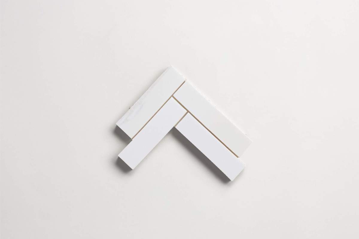 Tile bianco dolomite white stone herringbone sheet.