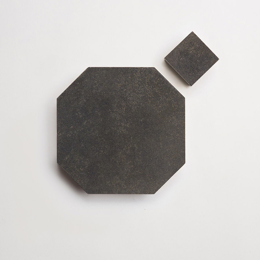 A large, dark octagonal tile and a smaller, matching square tile are placed on a plain white background.
