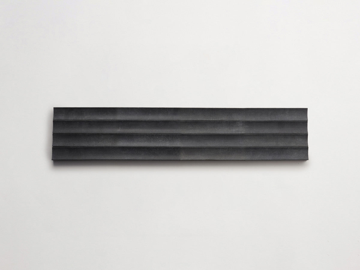 Lapidary fluted tile warm black 23.5 x 1.25.