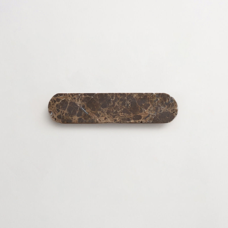 A rectangular tray with rounded edges made of dark brown marble, placed on a plain white background.