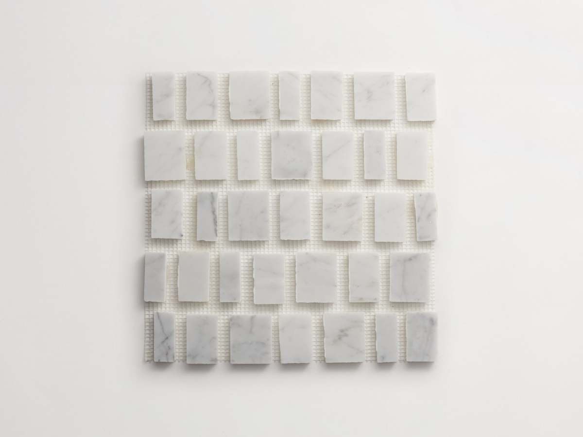 Carrara marble rough cut mosaic tile large joint.