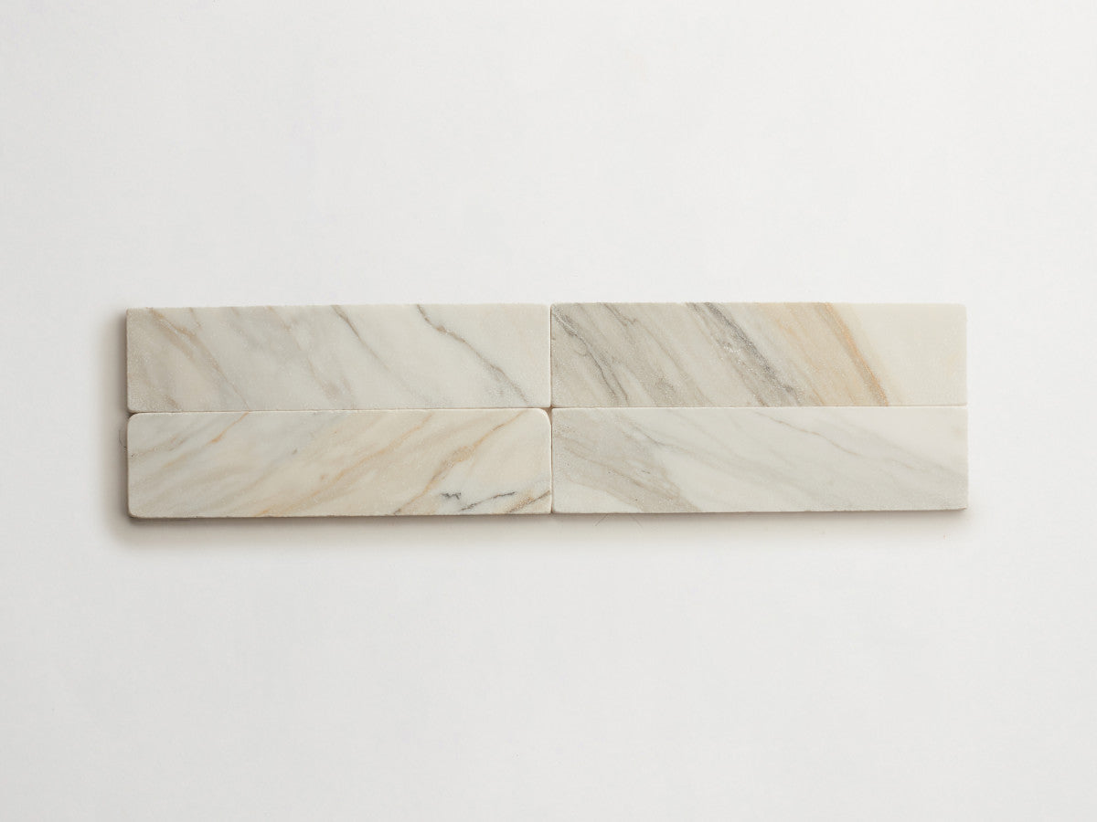 Lapidary stone tile 12 x 3 Calacatta Gold Tumbled.