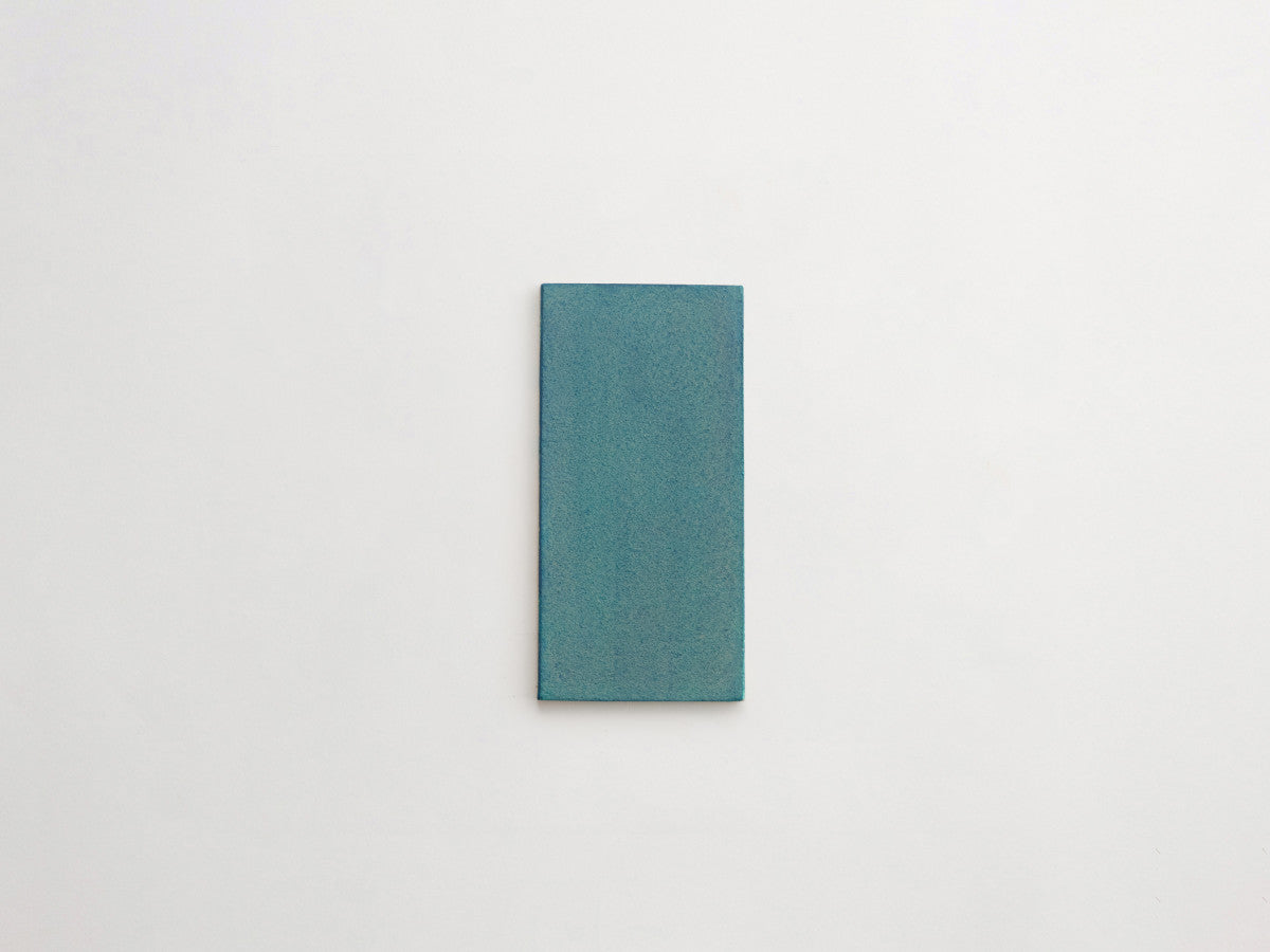 Ceramic Shibori Tile Natural 8x4 Teal Stain tile.