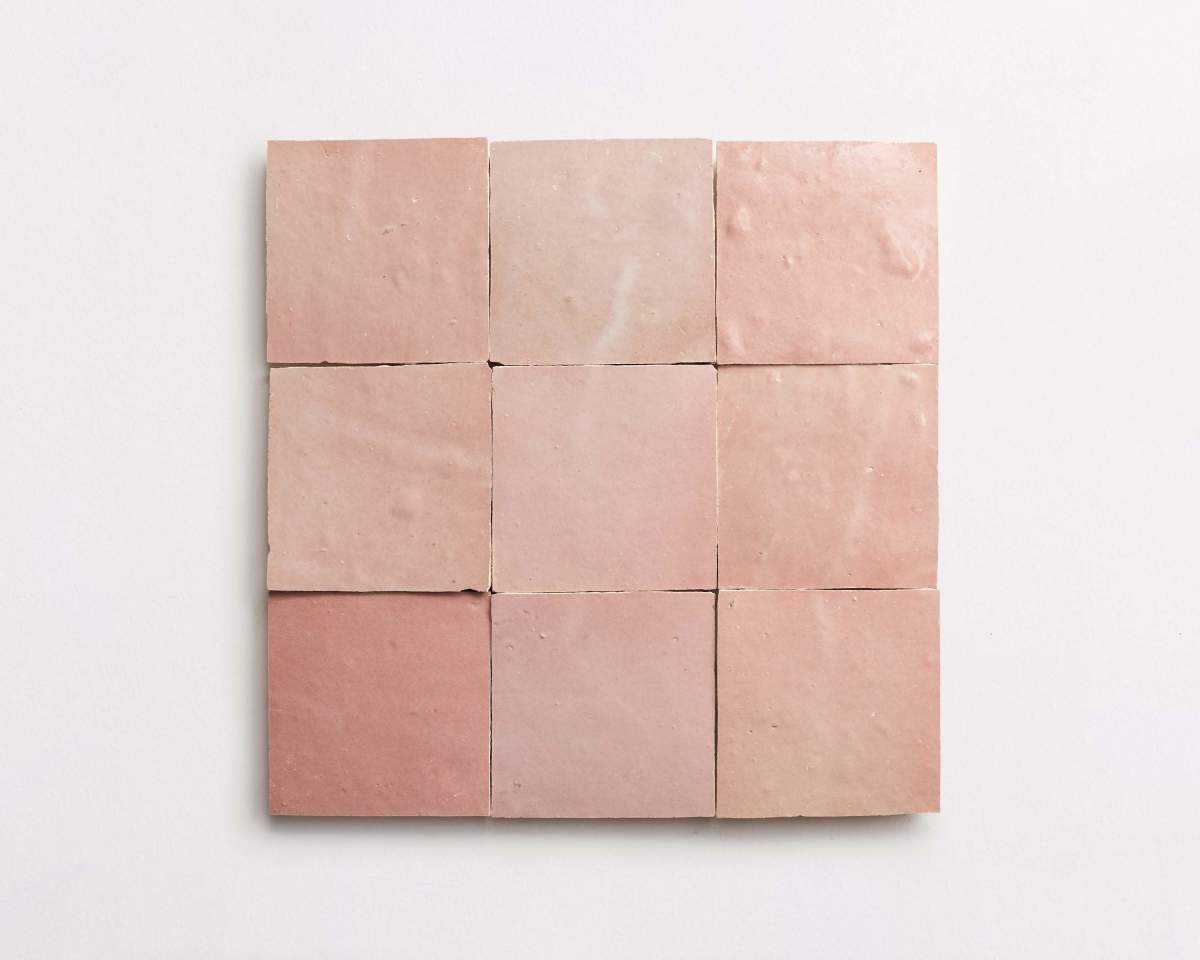 Nine square pink ceramic tiles arranged in a 3x3 grid on a white background.