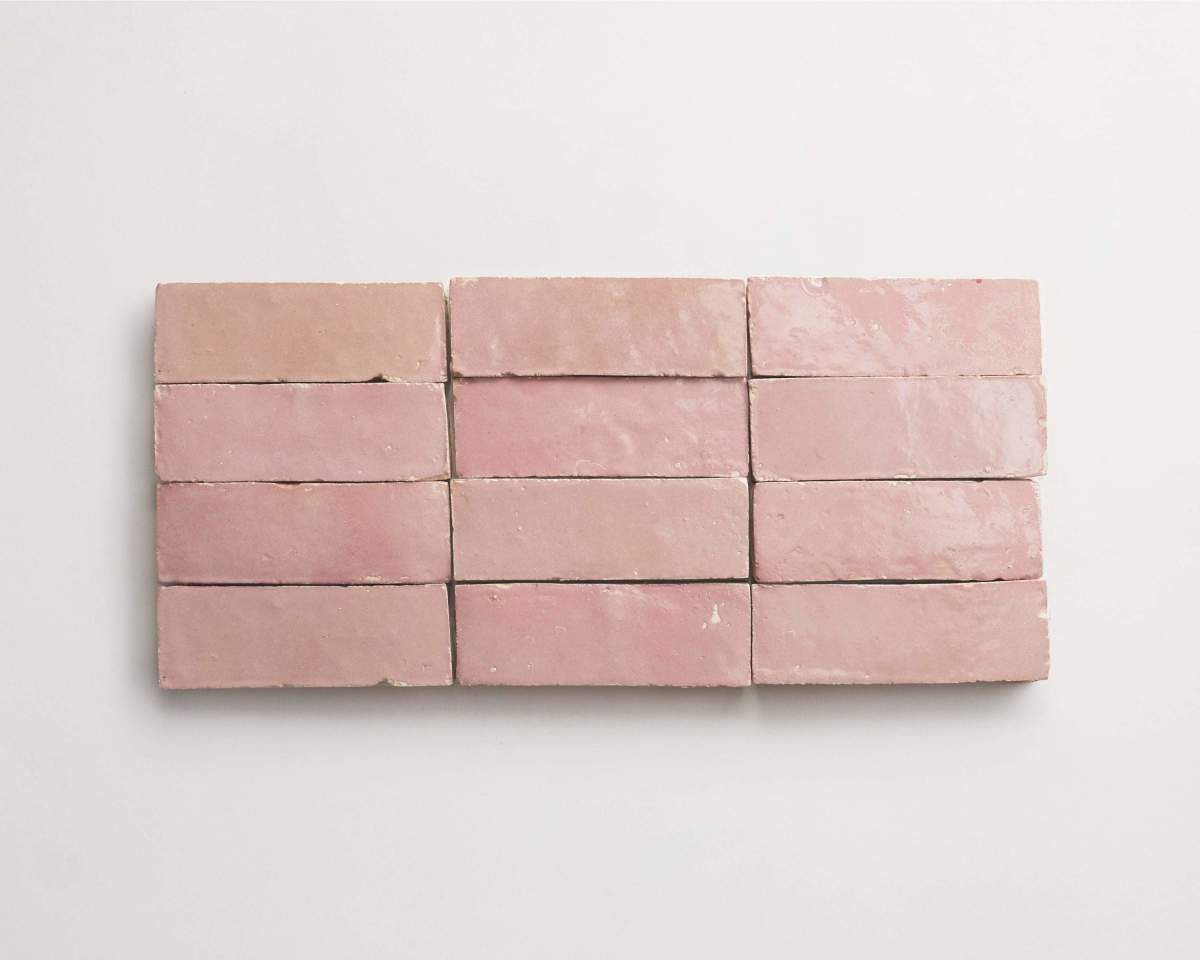 Twelve rectangular pink tiles are arranged in three rows of four on a white background.