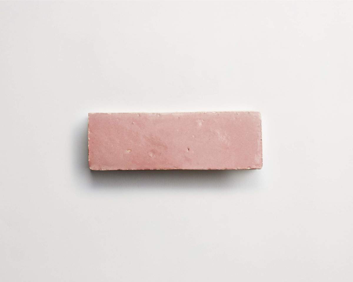 A rectangular pink block with a smooth surface is placed on a white background.