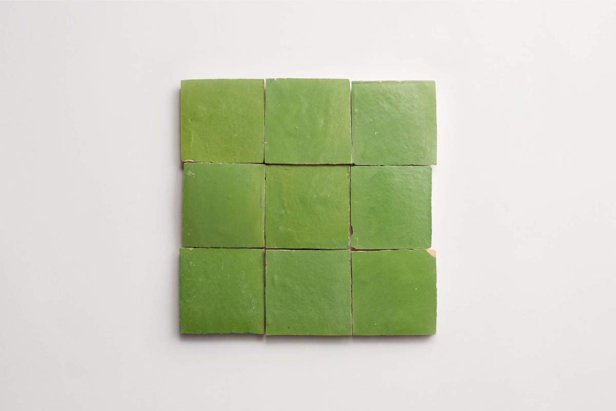 Nine square green tiles arranged in a three-by-three grid on a plain white background.