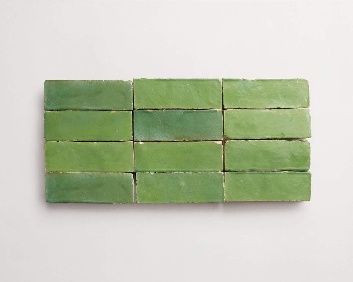 Twelve rectangular green tiles are arranged in three rows of four on a white background.