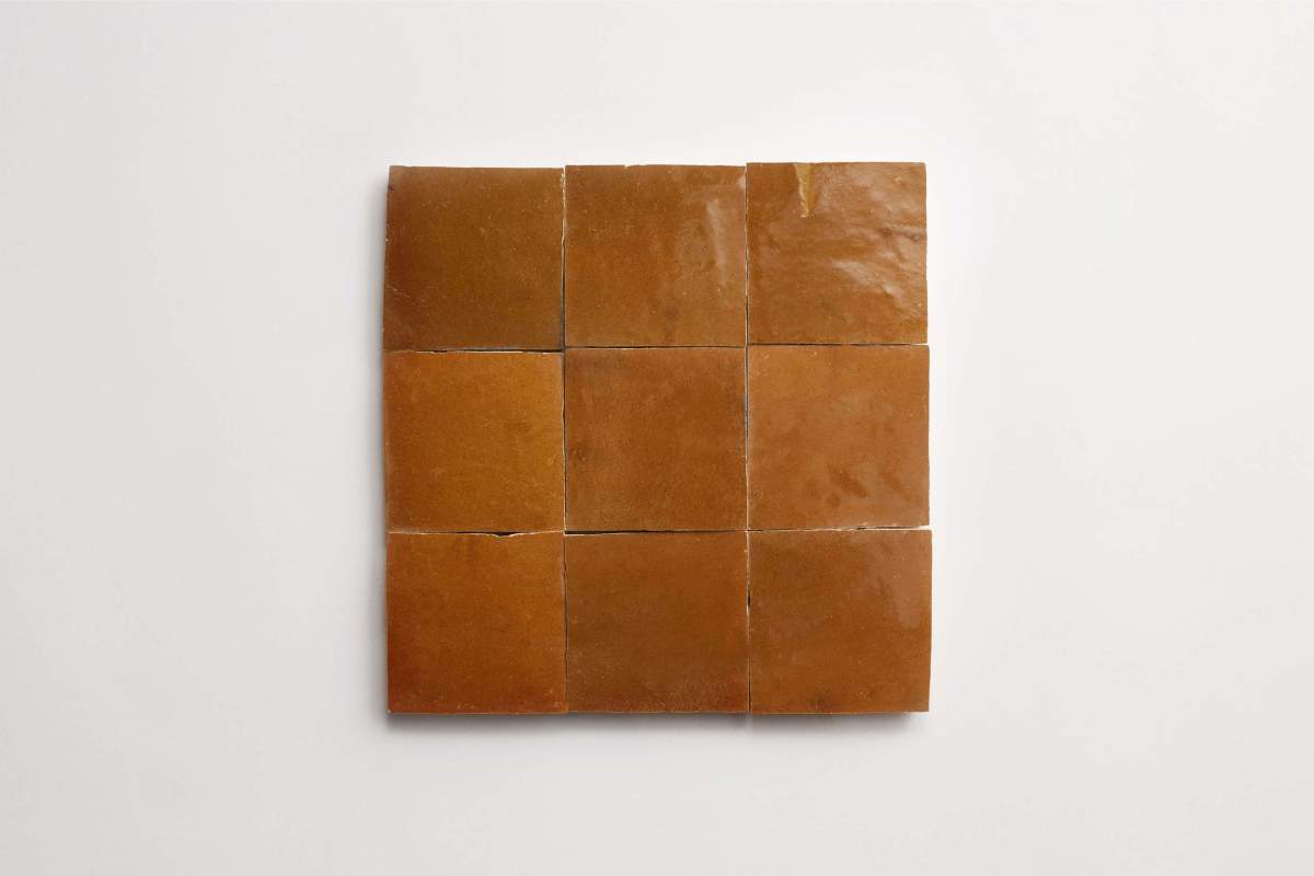 Nine square pieces of brown, glossy candy arranged in a three-by-three grid on a plain white background.