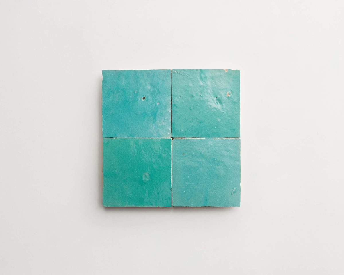 Four square teal tiles arranged in a 2x2 grid on a white background.