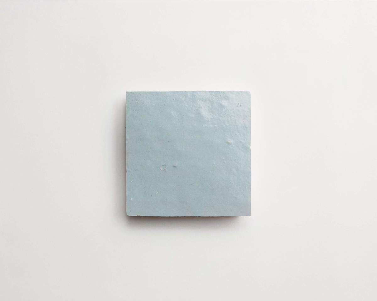 A single light blue square tile centered on a plain white background.