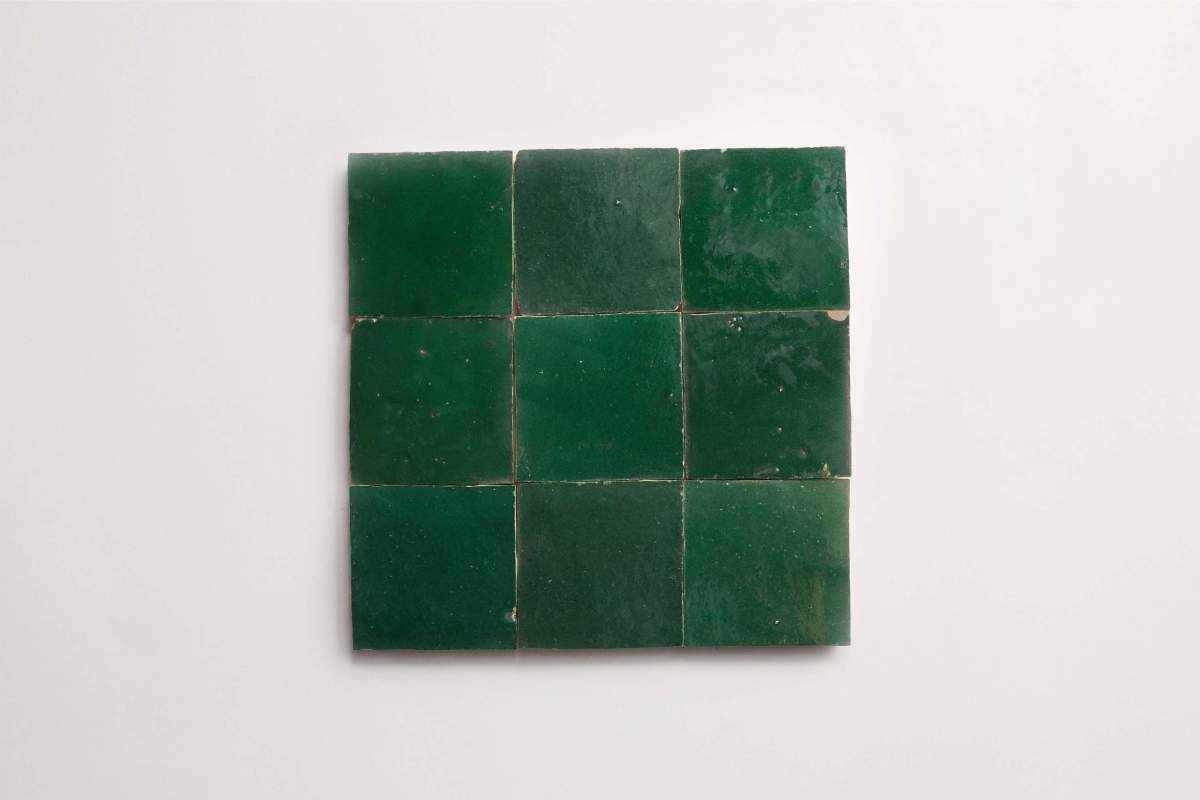 Nine square green tiles arranged in a 3x3 grid on a plain white background.