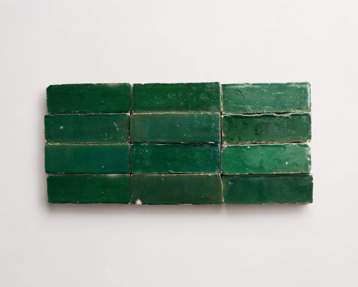 Twelve rectangular green tiles are arranged in a grid of three rows and four columns on a plain white background.