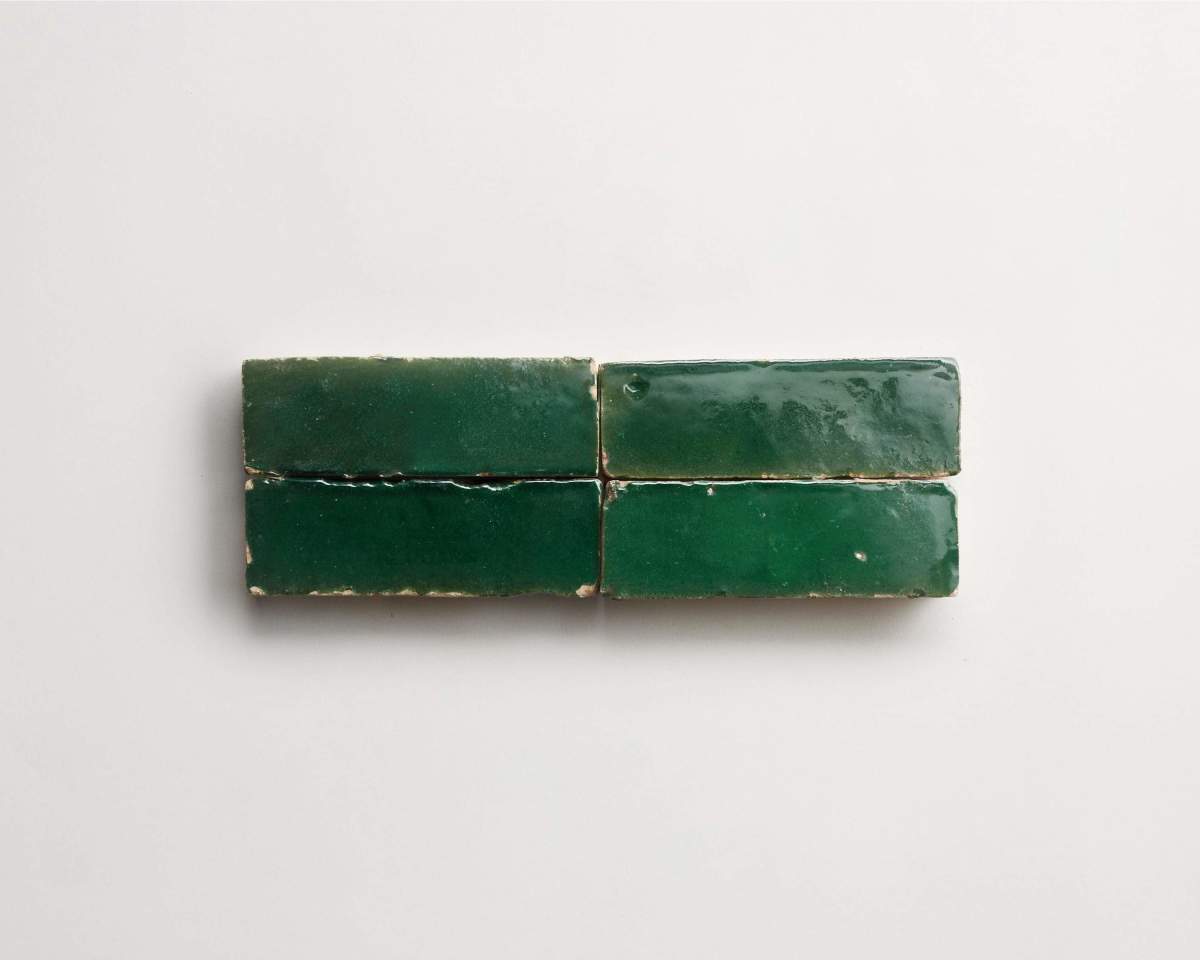 Four rectangular, glossy green tiles are arranged in two rows of two on a plain white background.